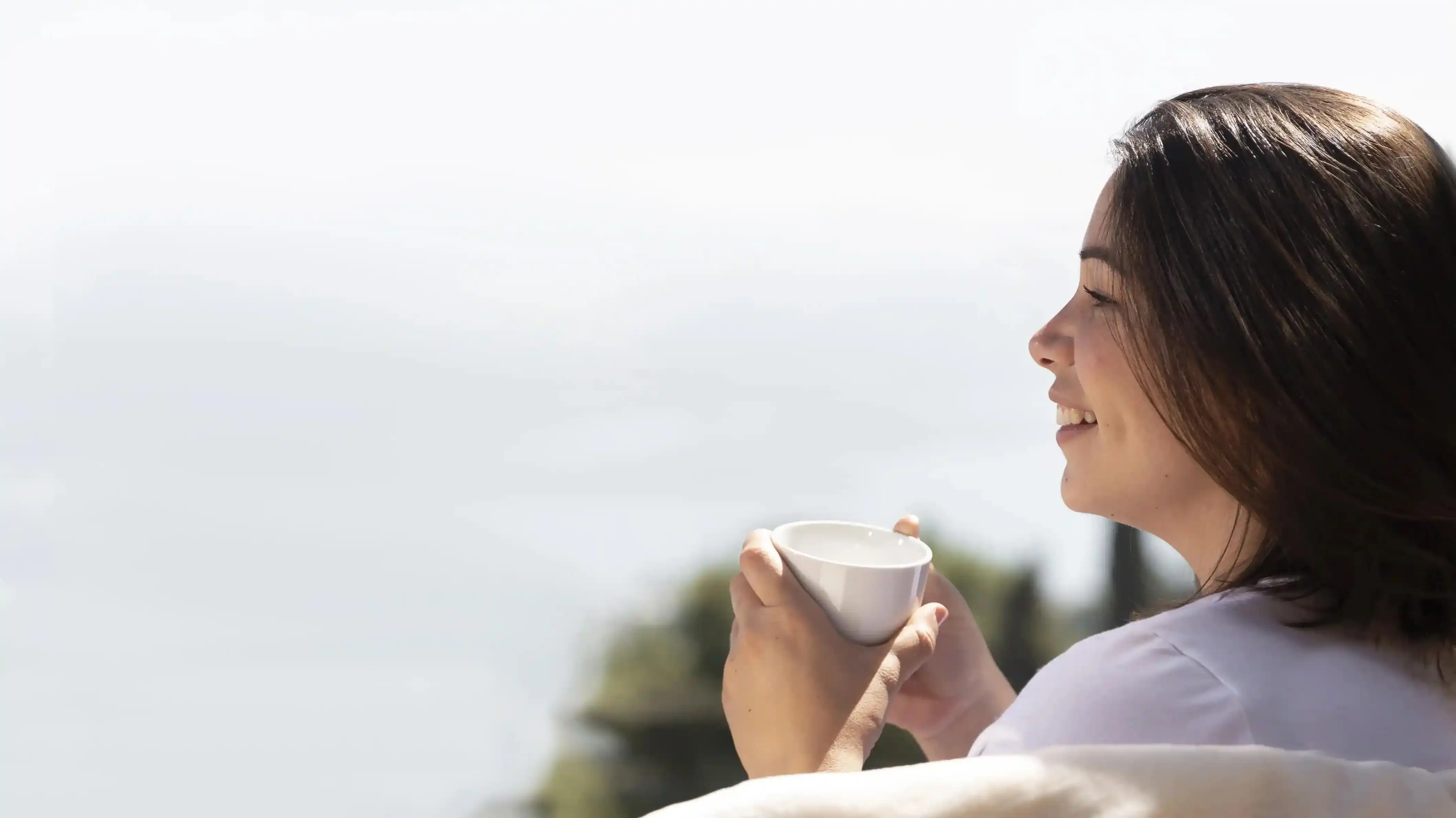 Woman Enjoying a Cup of PureFlow Detox Tea at Home